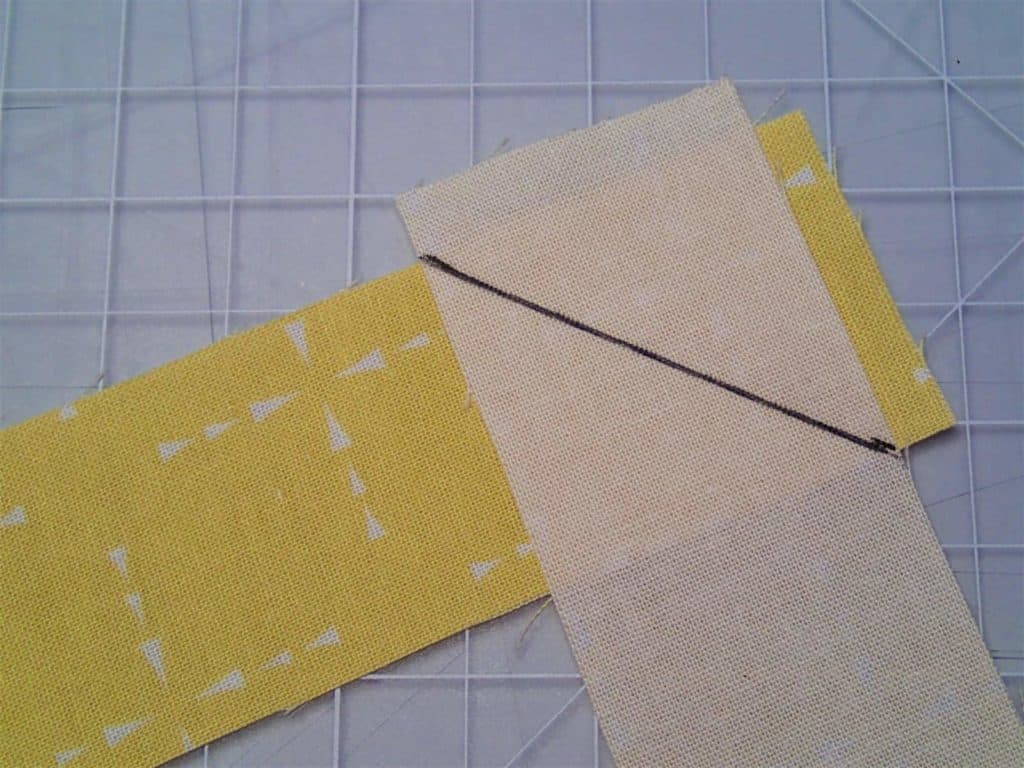 Binding pieces right sides together at right angles with a line drawn diagonally