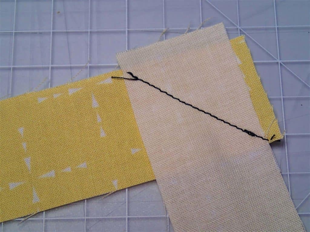 Two pieces of binding sewn with a diagonal seam